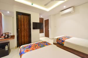 Ένα ή περισσότερα κρεβάτια σε δωμάτιο στο FabHotel Prime Prowell Apex - Nr Google office, Hitex, Kondapur