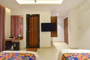 Ένα ή περισσότερα κρεβάτια σε δωμάτιο στο FabHotel Prime Prowell Apex - Nr Google office, Hitex, Kondapur