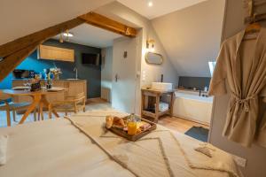 a bedroom with a bed with a tray of fruit on it at Les Secrets de la Baie - le Refuge - parenthèse enchantée avec Spa privatif in Étaples
