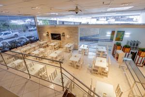 a restaurant with tables and chairs and a fireplace at Hotel San Gabriel in São Paulo +48 photos