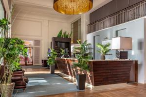 a lobby with potted plants and a reception desk at Cavendish Hotel in Eastbourne