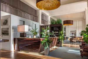a lobby of a hotel with potted plants at Cavendish Hotel in Eastbourne