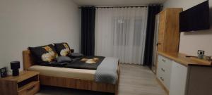 a bedroom with a bed and a dresser with a window at Biały Dom in Sarbinowo +36 photos