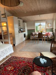 a living room with a table and a dining room at LillaStugan in Jönköping