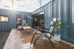 an empty room with a chair and a table at Riverside Sauna Base Conpeki in Taniai
