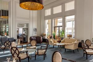 a lobby with chairs and tables and windows at Cavendish Hotel in Eastbourne +12 photos