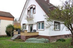 a white house with a staircase and a balcony at Projektunterkunft Wörth nähe MIRO - Mercedes Benz - Dachser in Wörth am Rhein