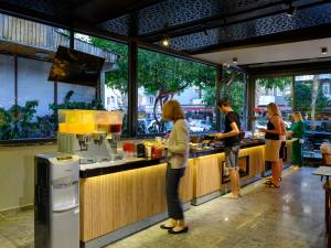 a group of people standing at the counter of a restaurant at Aria Riva Apart Hotel in Alanya +37 photos