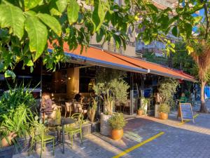 a restaurant with tables and chairs and plants at Aria Riva Apart Hotel in Alanya