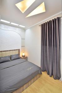 a bedroom with a bed and a window at Apart House in Yerevan Mashtots Avenue in Yerevan