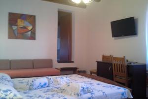 a bedroom with a bed and a couch and a television at B&B Morena in Labin +47 photos