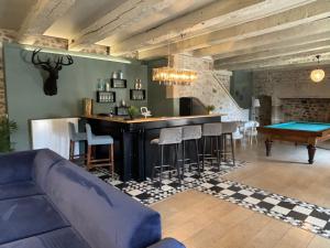 a living room with a bar and a pool table at Domaine des Annouillards in Sornac