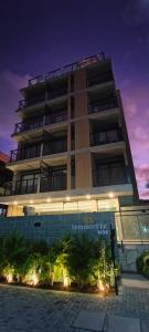 a tall building with a sign in front of it at Summer Flat Ap308 Intermares in Cabedelo +12 photos