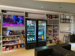 a soda shop with two refrigerators and a lot of drinks at Flat Guarulhos - 2 in Guarulhos