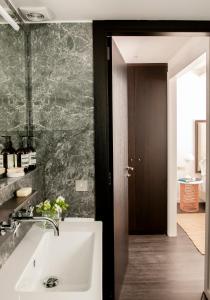 a bathroom with a white sink and a mirror at The Passage Homes - Simaba Group in Barcelona +149 photos