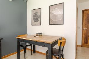 a dining room with a wooden table and chairs at The Lodge Chacras in Ciudad Lujan de Cuyo