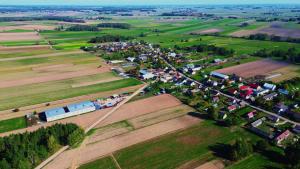 an aerial view of a farm with houses and trucks at Hostel S8 in Guty Bujno
