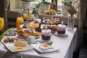a table with many plates of food on it at Apartment Pharos in Seevetal