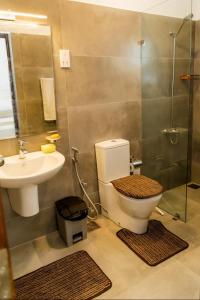 a bathroom with a toilet and a sink and a shower at Rose villa, Malabe in Kaduwela