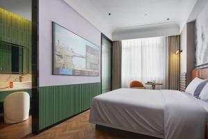 Ένα ή περισσότερα κρεβάτια σε δωμάτιο στο Renjoy Hotel -Xiamen Zhongshan Road Pedestrian Street