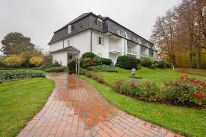 a house with a brick path in front of it at Ferienwohnung Leuchtfeuer in Brodten