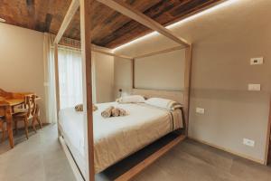 a bedroom with a bed with a large mirror at Tabia' Stelo Fiorito in Santo Stefano di Cadore