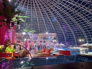 a large building with a domed ceiling and a pool at Luxurious 1 Br Facing Manila Bay Sunset Nearby Okada MOA Solaire Ayala Malls in Manila +51 photos