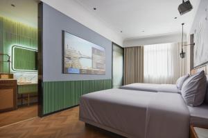 Ένα ή περισσότερα κρεβάτια σε δωμάτιο στο Renjoy Hotel -Xiamen Zhongshan Road Pedestrian Street