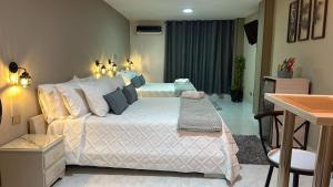 Postel nebo postele na pokoji v ubytování Provenza Medellin Hotel Boutique