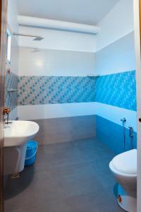 a bathroom with a white sink and a toilet at Marari Moriyah Homestay in Mararikulam +43 photos