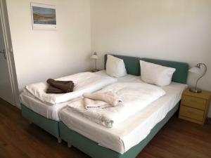 Postel nebo postele na pokoji v ubytování Gaestehaus _ Strandhalle
