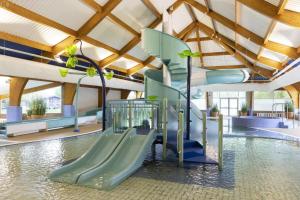 a playground with a slide in a swimming pool at Summer Breeze-Hoburne Cotswolds in South Cerney