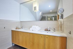 a bathroom with two sinks and a mirror at Žatecká - Terrace Residence in the Old Town in Prague +38 photos
