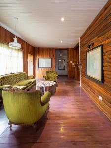 a living room with couches and a table and chairs at Wesley House Hosteria Boutique in San Martín de los Andes +44 photos