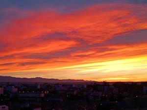 a view of a city at sunset at Chambre confort dans Appartement Partagé in Tarbes +5 photos