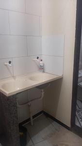 a bathroom with a white sink in a room at Casa Marataízes in Marataizes +3 photos