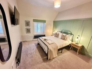 a bedroom with a large bed and a window at Luxury 3 bed, 6 person, spacious rural apartment in Cwm-brân
