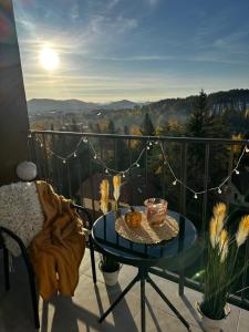 a glass table on a balcony with a view at Apartman Njegoš Lux Titova vila in Palisad