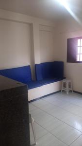 a room with a blue couch and a chair at Casa Marataízes in Marataizes