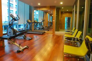 a gym with several treadmills and exercise bikes at BB Garden Resort in Bangkok