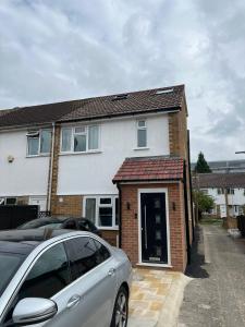 a house with a car parked in front of it at 93 New Road in Harmondsworth