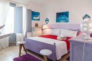 a bedroom with a bed with a dog laying on it at Le Terrazze in Otranto