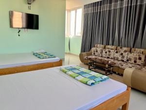 a living room with two beds and a couch at HT Phuong Thao Boutique in Nha Trang