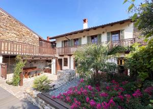 a courtyard of a house with flowers and plants at Rural Family Escape in Vipava