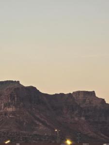 a view of a mountain with street lights in front of it at شقق عبدالله in Al-ʿUla