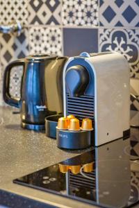 a toaster sitting on top of a kitchen counter at Le Charmant F2 rue du Gros Horloge à Rouen! in Rouen +13 photos