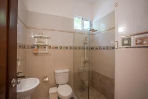 a bathroom with a toilet and a sink and a shower at Casa Estrellas Mirabal in Sosúa +21 photos