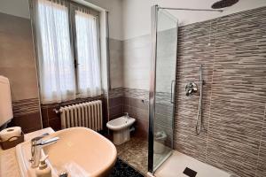 a bathroom with a shower and a sink and a toilet at Casa vacanze da Angela in Solto Collina +12 photos
