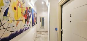 a hallway with a large painting on the wall at Il Magnifico Superior Rooms 400m from Tiburtina Railway Station and 290m from Metro in Rome