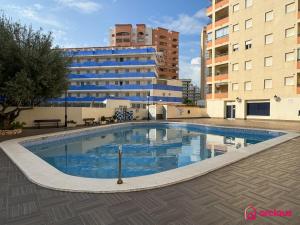 a large swimming pool in front of a building at La Marina in Oropesa del Mar +49 photos